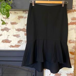 The limited black pencil skirt with flare at bottom